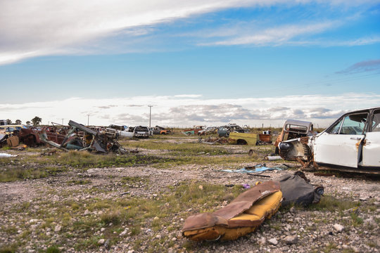 Old damaged cars on the junkyard waiting. Cemetery of cars.