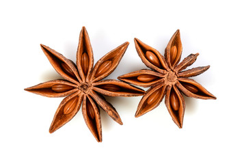 Star anise. Two star anise fruits. Macro close up Isolated on white background with shadow, top view of chinese badiane spice or Illicium verum.