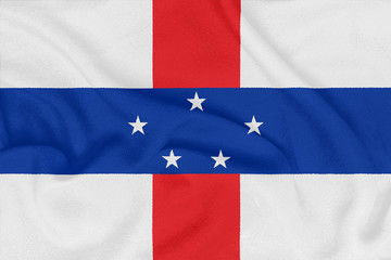 Flag of Netherlands Antilles on textured fabric. Patriotic symbol