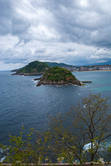 Vertical top view of coast landscape from Mount Igueldo in San Sebastian, Basque Country, Spain, Europe. With the island of Santa Clara. A cloudy morning of spring.