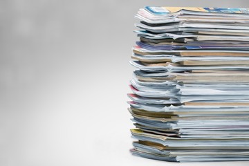 Pile of newspapers on white background