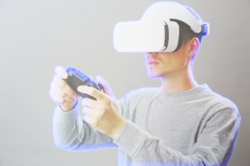 Man with virtual reality headset is playing game. Image with hologram effect.