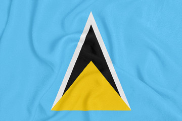 Flag of Saint Lucia on textured fabric. Patriotic symbol