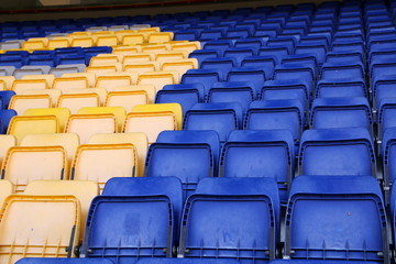 Fototapeta premium The blueand yellow seats make an interesting pattern at the stadium.