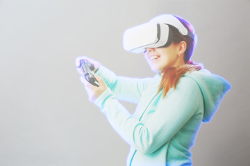 Woman with virtual reality headset is playing game. Image with hologram effect.
