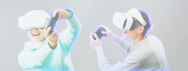 Man and woman with virtual reality headset are playing game. Image with hologram effect.