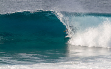 A Surfer riding in a barrel wave