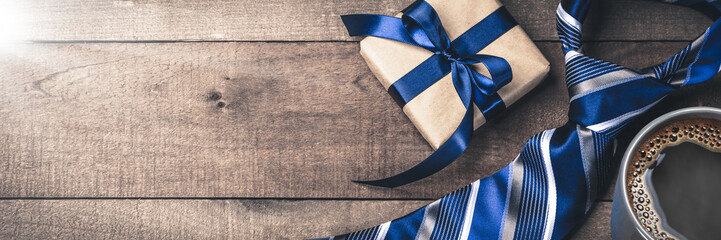 Gift Box Tie And Hot Coffee On Wooden Table With Sunlight - Fathers Day Concept