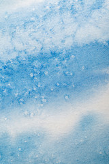 close up view of blue watercolor paint spill with dots on textured background