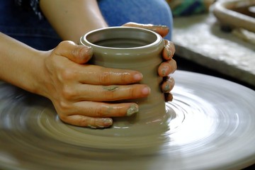 A female hands making a vase in a pottery workshop in indoor place area 