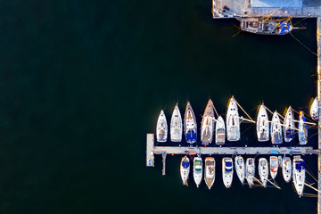 Aerial View by Drone of yachts and small motor boats. White boats in sea water. Yacht and sailboat...