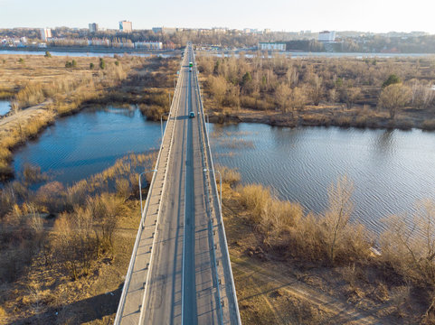 Panorama of a small town, river, forest, fields, road, bridge and sky. The photo was taken by a quadcopter, drone. Summer and spring. Skyview. Top view. Travel and tourism. Created by DGJ drone.
