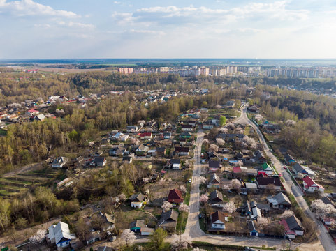 Panorama of a small town, river, forest, fields, road, bridge and sky. The photo was taken by a quadcopter, drone. Summer and spring. Skyview. Top view. Travel and tourism. Created by DGJ drone.