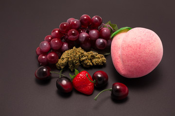 Cannabis flower and fruit on black background
