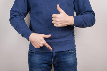 Cropped close-up photo of satisfied confident cool guy demonstrating pointing on his he organ in...
