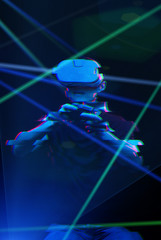 Man with virtual reality headset is playing game. Image with glitch effect.