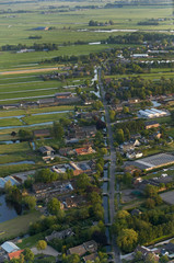 Aerial view of dutch farmland village along rural road