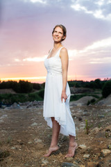 woman in white dress on the background of blue sky