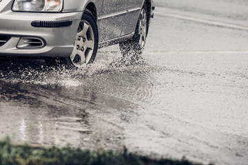 motion car rain big puddle of water spray 