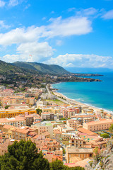 Obraz premium Stunning landscape of coastal city Cefalu in beautiful Sicily captured on a vertical picture. Taken from the adjacent hills overlooking the bay on Tyrrhenian coast. Popular tourist spot