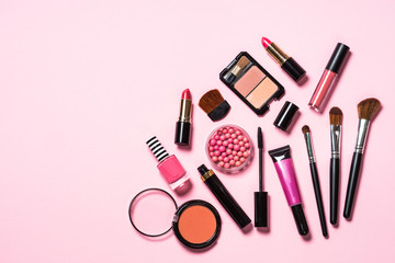 Makeup professional cosmetics on pink background.