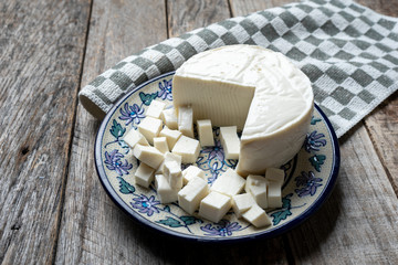 Fresh and tasty mexican panela cheese on wood background