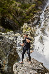 Muay thai fighter training by the waterfall