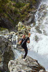 Muay thai fighter training by the waterfall