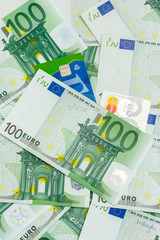 Many Banknotes of 100 Euro and Two Credit and Debit Cards, Pile of the European Currency Background