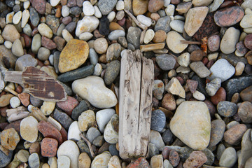 background of pebbles and driftwood on the beach