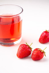 Strawberries with compote drink in glass isolated on white background