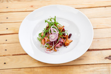 vegetarian salad with beetroot, honey agaric and red onion