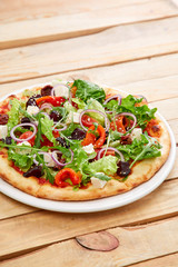 vegetarian pizza with fresh tomatoes, olives, tofu and red onion