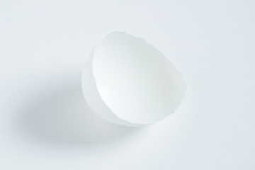 Half an egg shell on a white background.