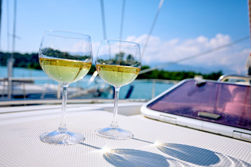 Pair of wineglasses against the yacht