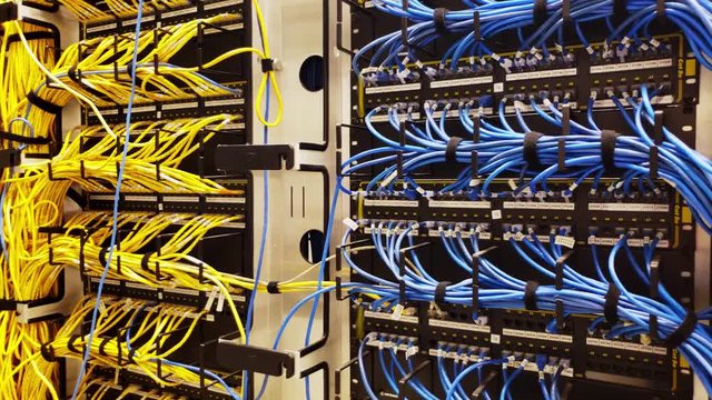 Rack with generic ethernet cat5e cables, part of a large company data center