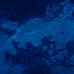 Abstract dark blue gradient paint background. Acrylic texture space nebula like pattern. Rough uneven surface. Design idea.