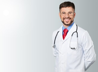 Male doctor with stethoscope on hospital background