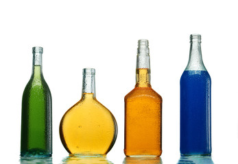 Various alcoholic drinks in transparent bottles