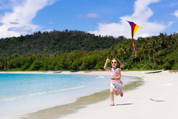 Child with kite. Kids play. Family beach vacation.