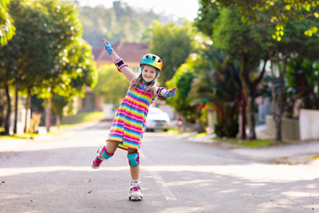 Child on inline skates. Kids skate roller blades.