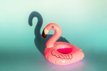 Giant inflatable Flamingo on a blue background, pool float party, trendy summer concept