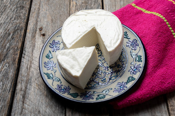 Fresh and tasty mexican panela cheese on wood background