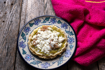 Mexican food: sopes with green sauce and beans