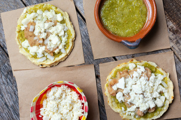 Mexican food: sopes with green sauce and beans