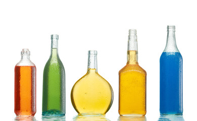 Various alcoholic drinks in transparent bottles