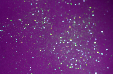 Purple sparkling shiny blurred background. Festive backdrop.