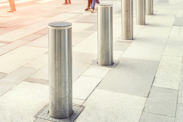 Stainless steel bollard entering pedestrian area on Vienna city street. Car and vehicle traffic access control - obrazy, fototapety, plakaty