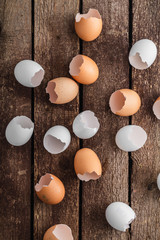 Empty egg shells on wooden background, top view