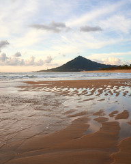 Beach of moledo at the end of the day, with a view to trega mountain on spanish side of the border. Low tide displaying the sandy beach on a cloudy day.
